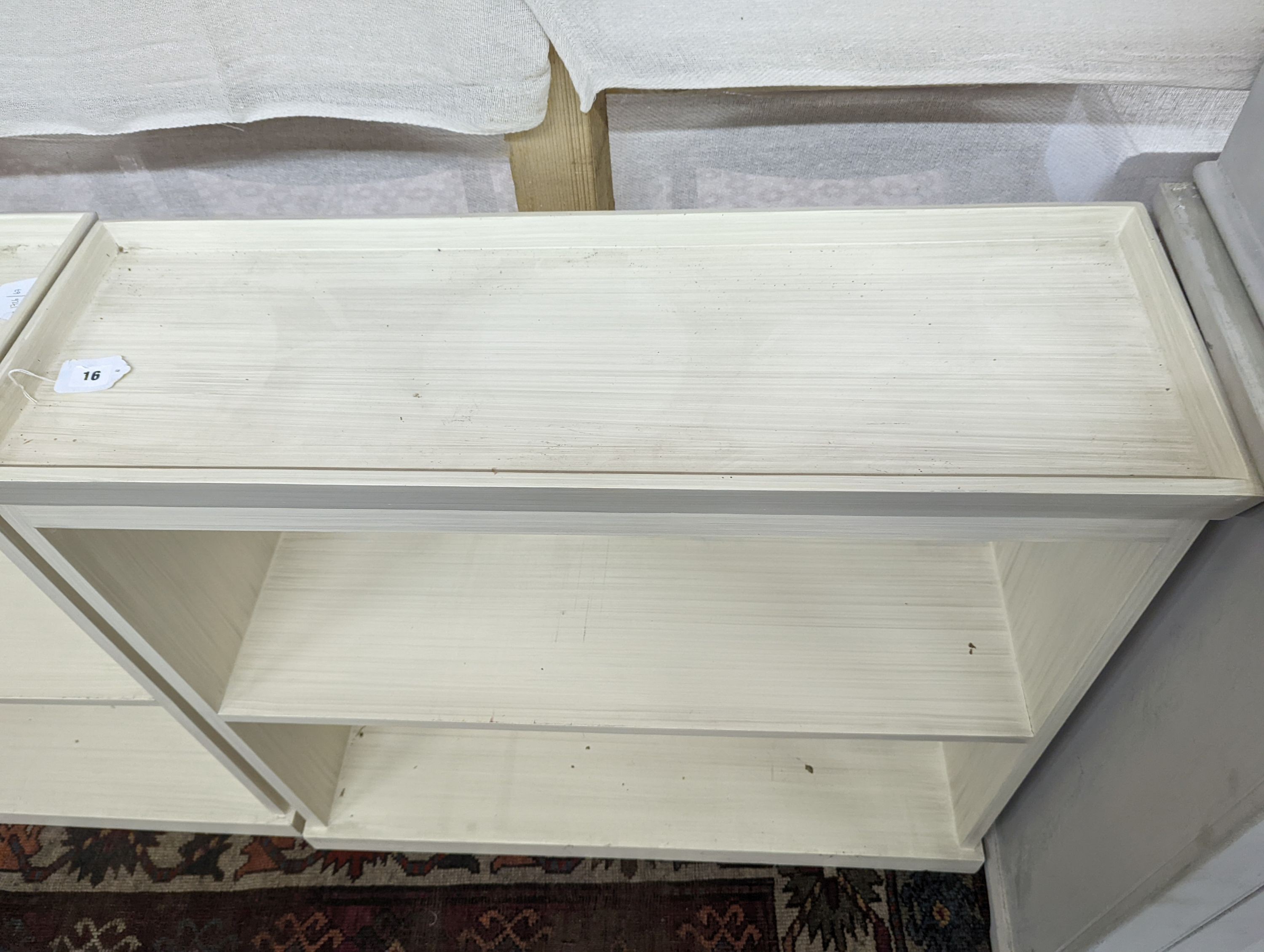 A pair of modern white painted dwarf open bookcases, length 90cm, depth 30cm, height 82cm
